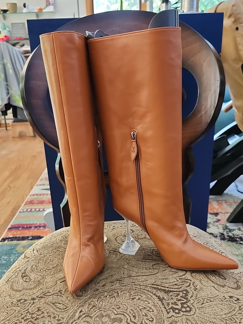 Amina Muaddi 95mm Knee-High Leather Boots with Flared Martini Heel in Cognac